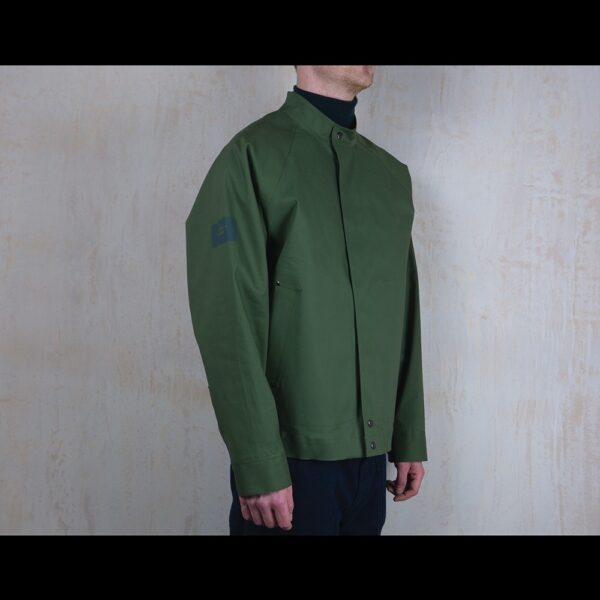 Logo-Side-View-Of-Model-Wearing-Waterproof-Green-Rain-Jacket-By-Rainford-Apparel