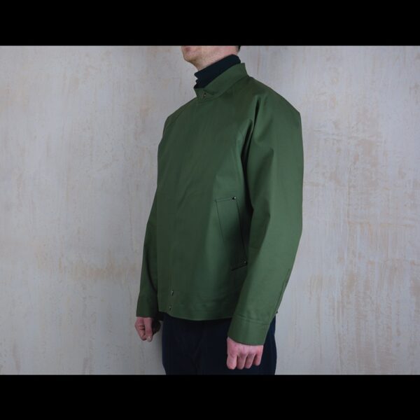 Side-View-Of-Model-Wearing-Waterproof-Green-Rain-jacket-By-Rainford-Apparel