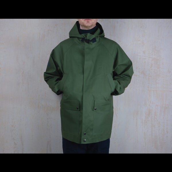 Front-View-Of-Model-Wearing-Waterproof-Green-Rain-Parka-By-Rainford-Apparel