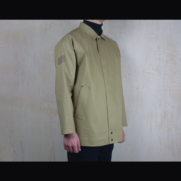Logo-Side-View-Of-Model-Wearing-Waterproof-Caramac-Raincoat-By-Rainford-Apparel