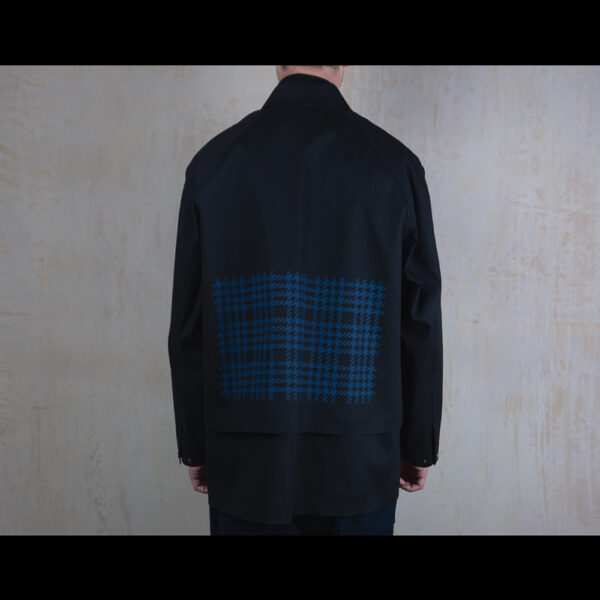 Back-View-Of-Model-Wearing-Waterproof-Houndstooth-Print-Rain-Jacket-By-Rainford-Apparel