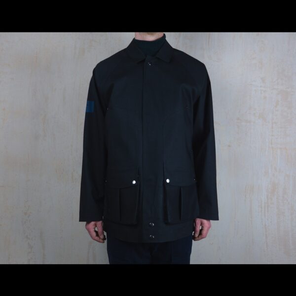 Front-View-Of-Model-Wearing-Waterproof-Houndstooth-Print-Rain-Jacket-By-Rainford-Apparel