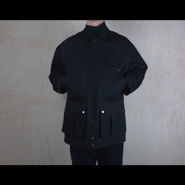 Front-View-Of-Model-Wearing-Waterproof-Houndstooth-Print-Rain-Jacket-By-Rainford-Apparel