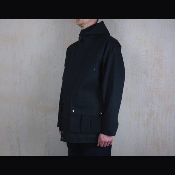 Side-View-Of-Model-Wearing-Waterproof-Houndstooth-Print-Rain-Parka-By-Rainford-Apparel