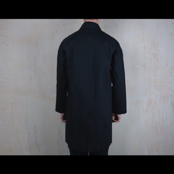 Back-View-Of-Model-Wearing-Black-Waterproof-Reinford-Raincoat-By-Rainford-Apparel