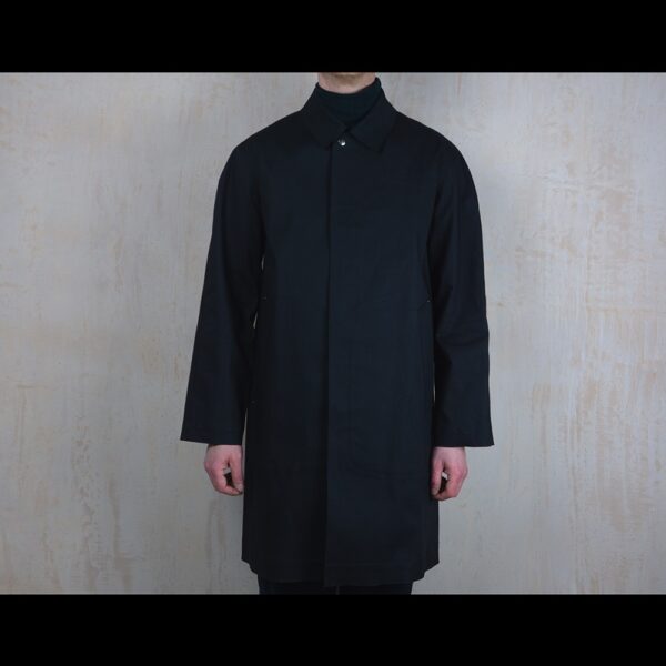 Front-View-Of-Model-Wearing-Waterproof-Black-Reinford-Raincoat-By-Rainford-Apparel
